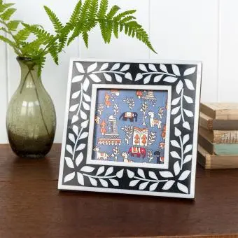 Square picture frame with white leaf patterns and navy blue colour on the border.