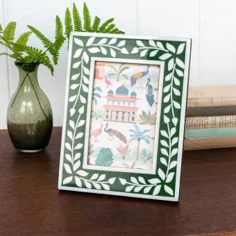 picture frame with a green border and white leaf patterns