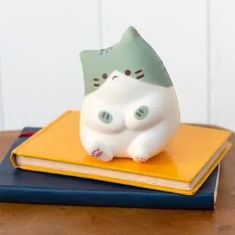 Green and white squidgy stress cat in a sitting design