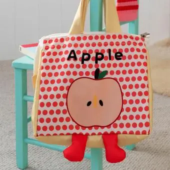 Yellow handbag with red polka dots and a cartoon apple design with two red feet at the bottom