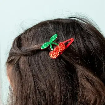 Pair of red glitter cherry hair clips with green glitter leaves