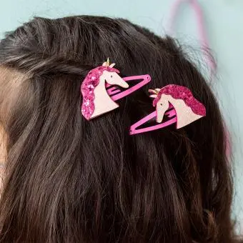 Pair of pink hair clips with glittery unicorn heads