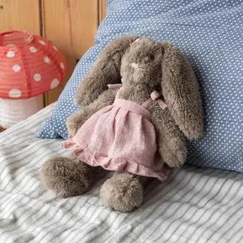 Plush bunny toy with floppy ears, wearing a pink dress