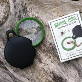 Nature Trail pocket magnifying glass with green frame, black leather case, and illustrated packaging.
