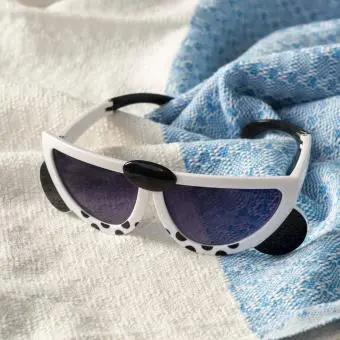 sunglasses with white snow leopard design, black spots, and dark lenses