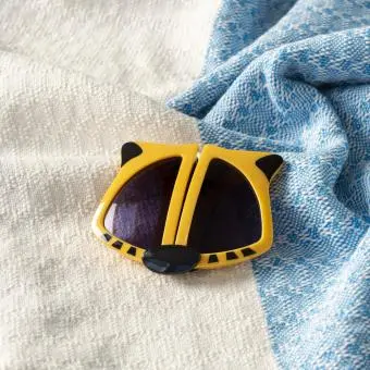 sunglasses with yellow tiger design, black stripes, and dark lenses.