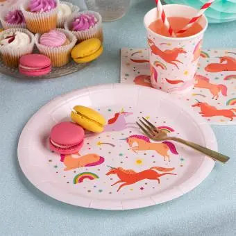 Pink unicorn-themed paper plate displayed with macarons and matching cup and napkin.