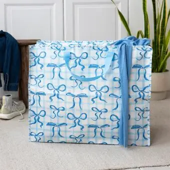 Large storage bag with a light blue gingham pattern and blue bow illustrations with handles.