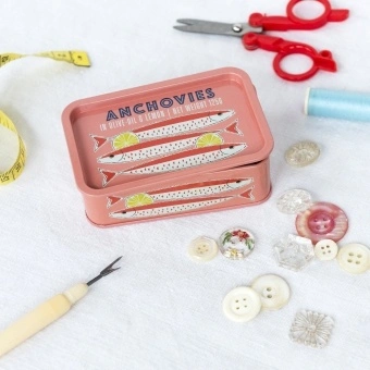 Pink mini storage tin with an illustrated anchovies fish on the front.