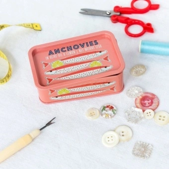 Pink mini storage tin with an illustrated anchovies fish on the front.