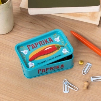 Mini storage tin with paprika illustration on the front.
