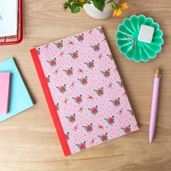 Pink notebook with a french rose design on the cover.