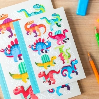 Notebook with colourful dinosaurs on a light background.