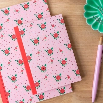 Pink notebook with a french rose design on the cover.