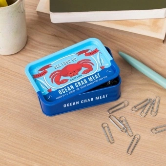 Blue mini storage tin with an illustrated crab on the front.
