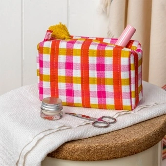 Pink and yellow gingham quilted makeup bag with a zip and tassel.