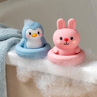 Silicone bath toy in pink bunny and blue penguin design