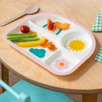Rainbow garden-themed toddler divider plate shown with vegetables and fruits on a wooden table.