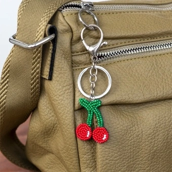 Cherry keyring with green stems and silver ring and clip attachment.