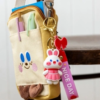 Bunny bag charm with pink outfit, silicone wrist strap and bow detail