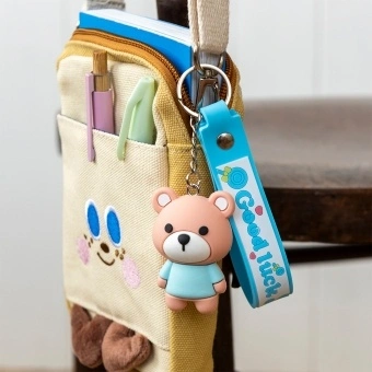 Bear bag charm with blue outfit, silicone wrist strap and silver keyring