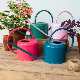 metal watering cans in different colour.
