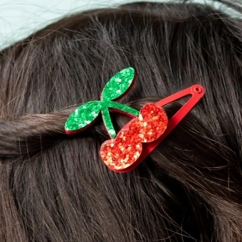 Red glitter cherry hair clip with green glitter leaves