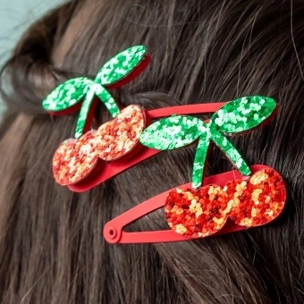 Pair of red glitter cherry hair clips with green glitter leaves