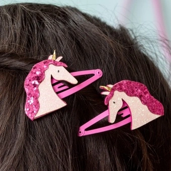 Pair of pink hair clips with glittery unicorn heads