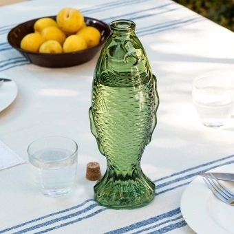 Green fish-shaped glass bottle with embossed scale pattern and cork stopper