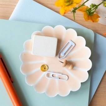 soft pink enamel flower-shaped trinket dish holding clips and small items