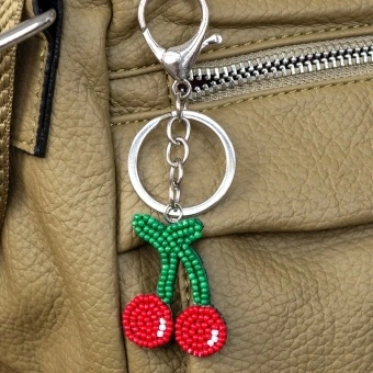 Cherry keyring with green stems and silver ring and clip attachment.