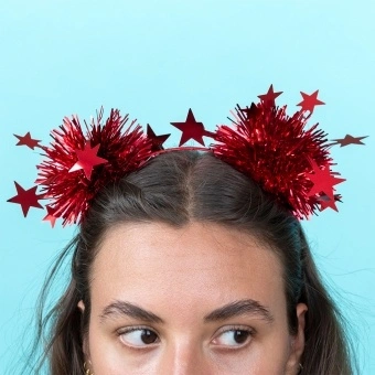 Red party headband with tinsel pom-poms and star decorations.