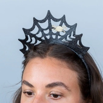 Black glitter spiderweb headband with a gold spider decoration.