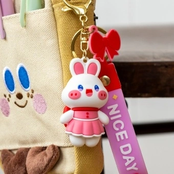 Bunny bag charm with pink outfit, silicone wrist strap and bow detail