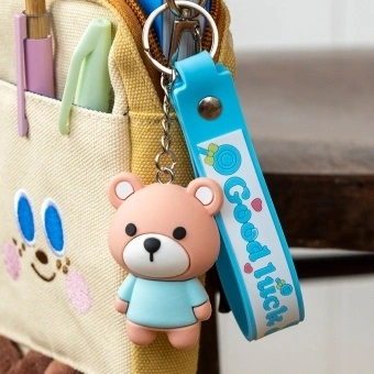 Bear bag charm with blue outfit, silicone wrist strap and silver keyring