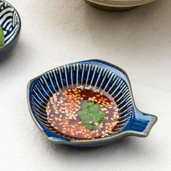 Fish-shaped blue ceramic dipping bowl shown with dipping sauce.