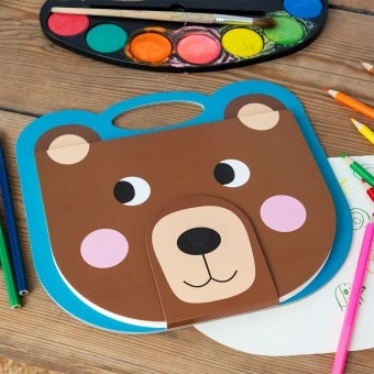 Brown bear-faced sketchbook with a blue handle, round ears, pink cheeks and smile.