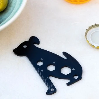 Dog-shaped multi-tool with ruler and wrench cut-outs.