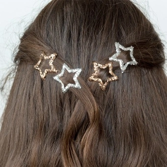 Silver and gold glitter star hair clips in a set of four.