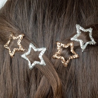 Silver and gold glitter star hair clips in a set of four.
