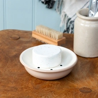 Round two-part soap dish with drainage holes.