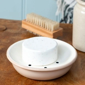 Round two-part soap dish with drainage holes.