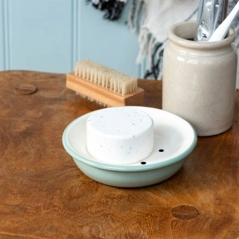 Round two-part soap dish with drainage holes in sage green.