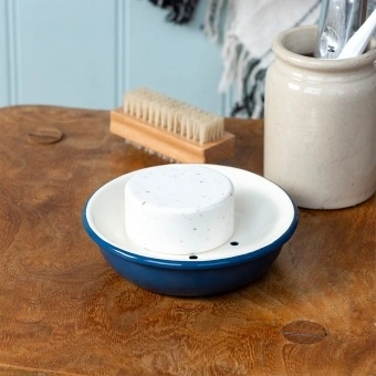 Round two-part soap dish with drainage holes in blue.