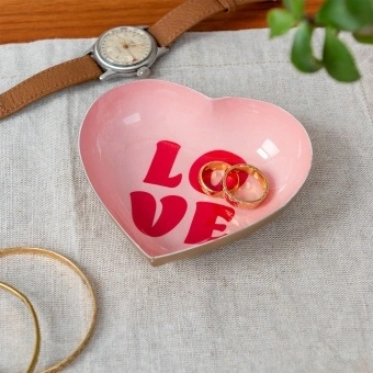 Heart-shaped pink trinket dish with red “LOVE” text