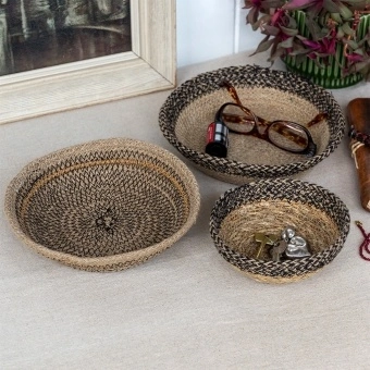 Round decorative bowl with natural and black woven detail.