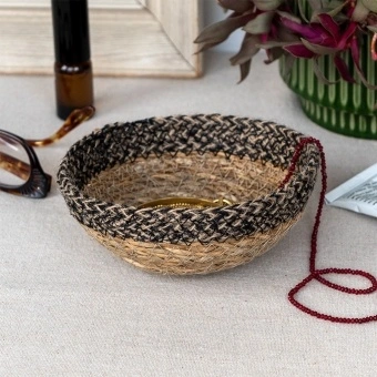 Round seagrass bowl with natural and black woven detail.