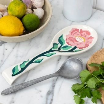 White ceramic spoon rest with blue fish design.
