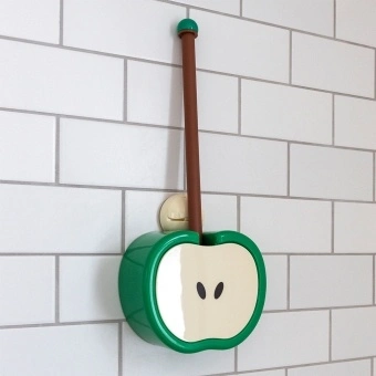 Green apple-shaped toilet brush and holder with wall mount, displayed against white tiled wall.